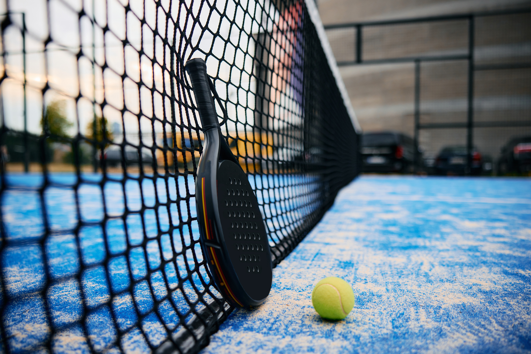 A padel court net and glass wall